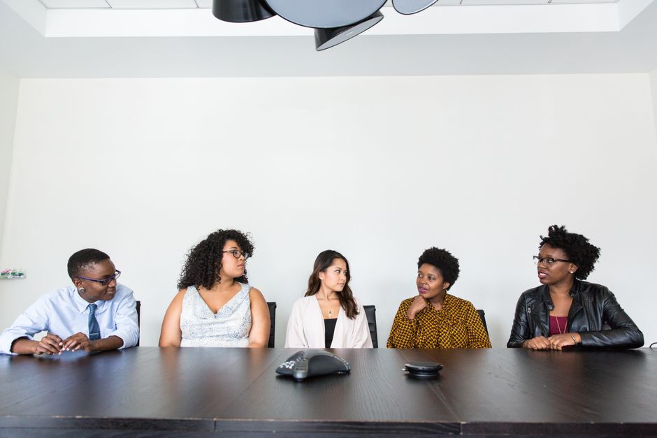 A diverse group of professionals having a meeting in a modern office setting.